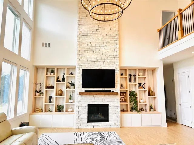 a living room with fireplace furniture and a flat screen tv