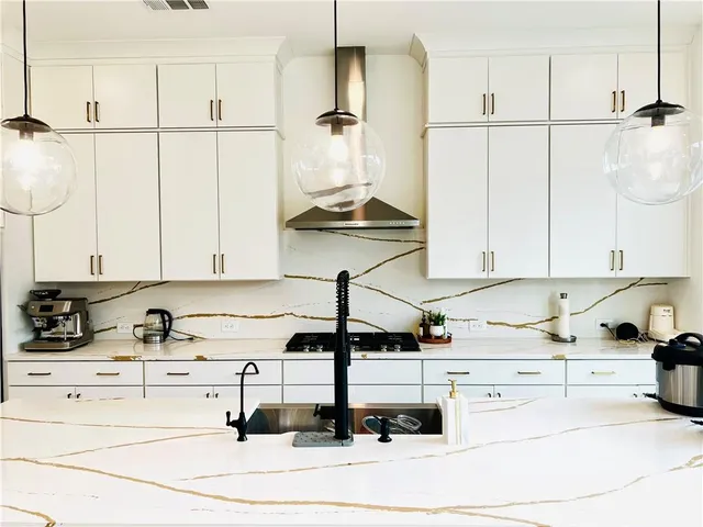 a kitchen with a white cabinets and appliances