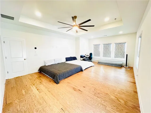 a bedroom with a large bed and a chandelier