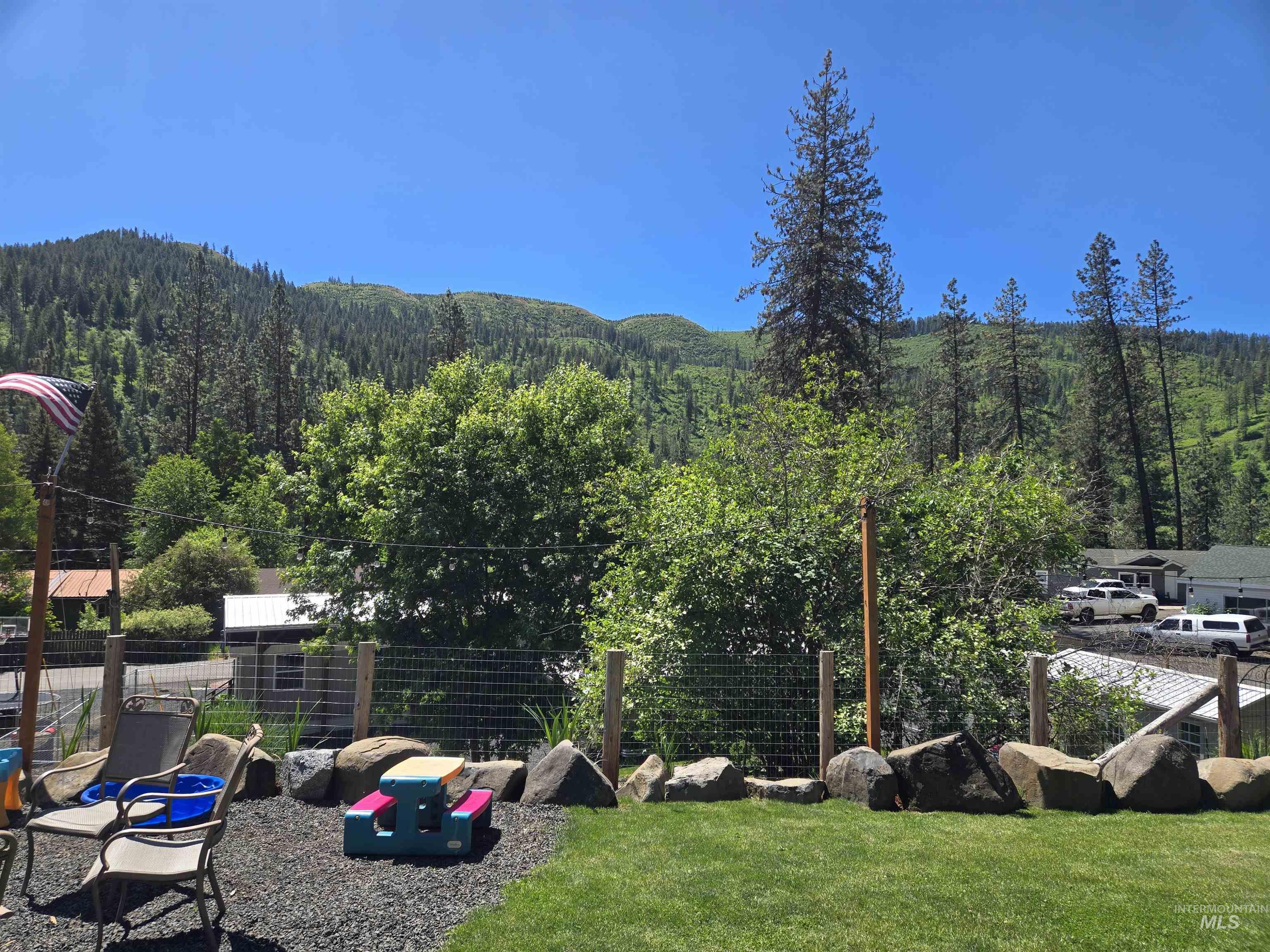 174 Konkolville Road Orofino, ID 83544 - Photo 38 of 43 Expansive green lawn with a rock border and a gravel patio area