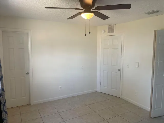 a view of an empty room with a fan