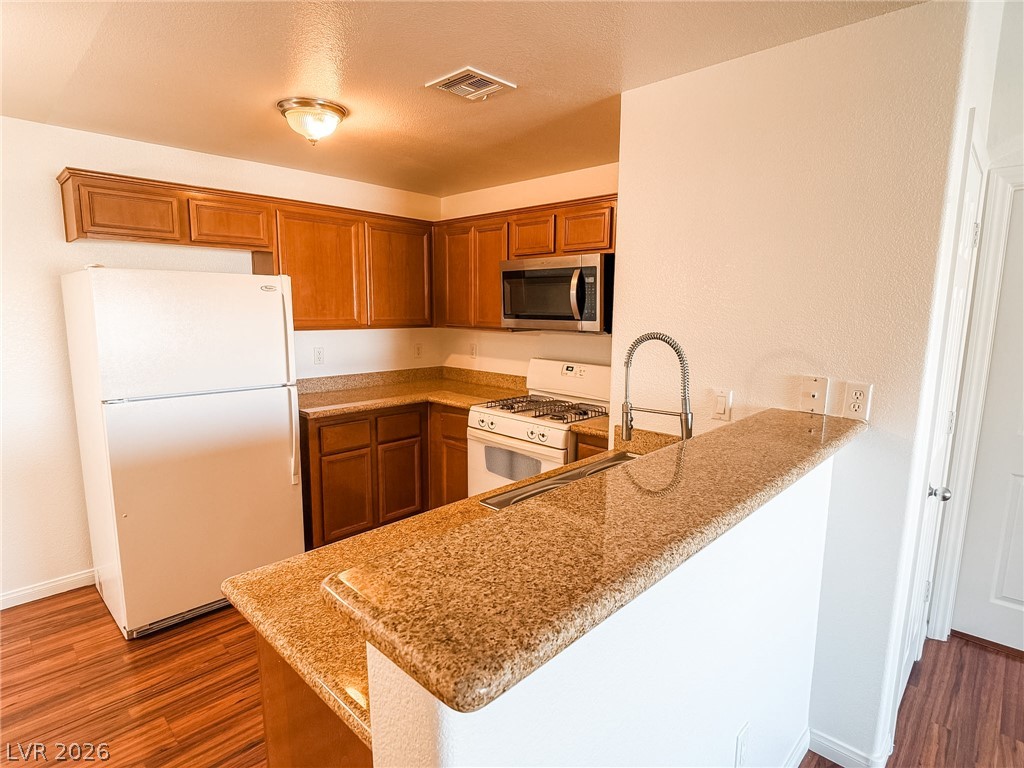 7701 West Robindale Road, Unit 110 Las Vegas, NV 89113 - Photo 7 of 21 Culinary delights await in this modern kitchen with ample counter space and appliances.