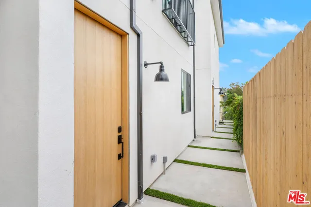 a view of a balcony with wooden floor and door