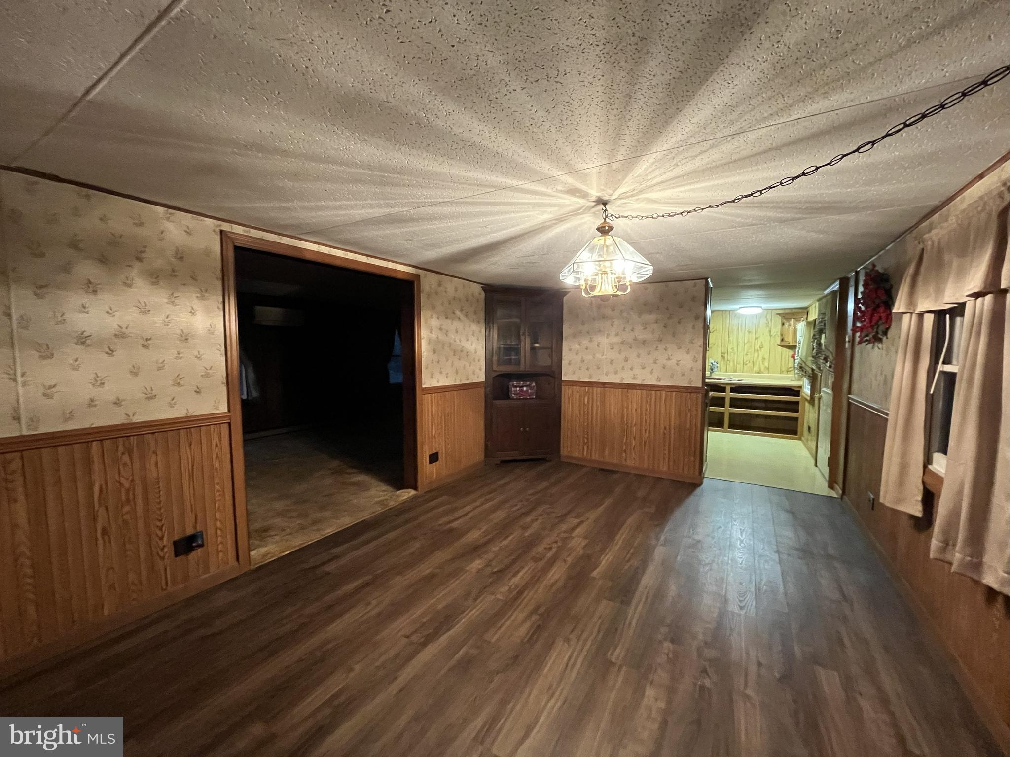 512 Brosius Hill Road Mount Pleasant Mills, PA 17853 - Photo 14 of 59 a view of a hallway with wooden floor and a kitchen