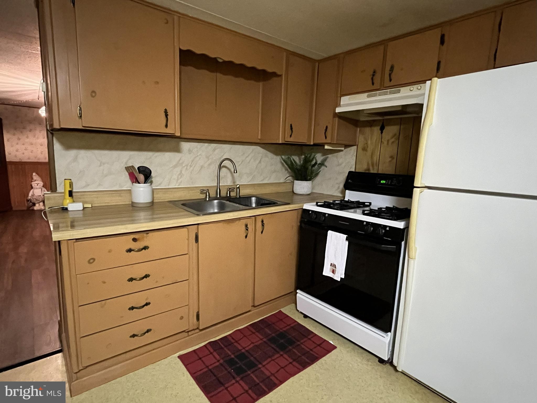 512 Brosius Hill Road Mount Pleasant Mills, PA 17853 - Photo 6 of 59 a kitchen with granite countertop a refrigerator sink and cabinets