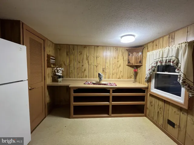 a kitchen with refrigerator and cabinets
