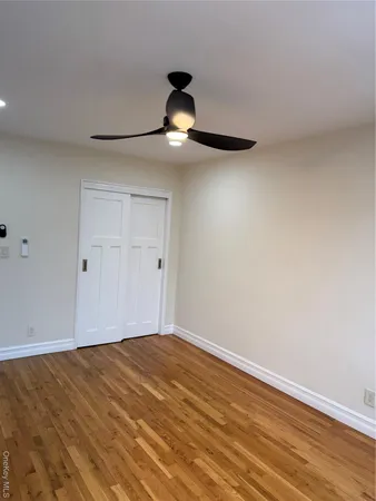a view of an empty room and wooden floor