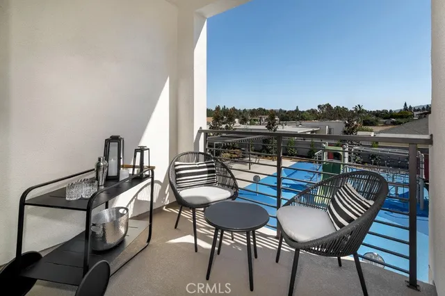a view of a chairs and table in the balcony