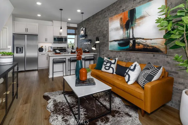 a living room with fireplace furniture and a potted plant