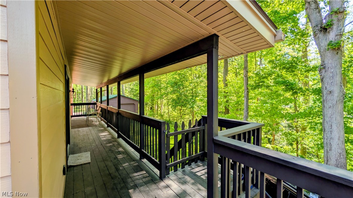 6409 Old Woods Road Ashtabula, OH 44004 - Photo 39 of 43 Expansive covered porch featuring wood-finish decking and dark-stained railings