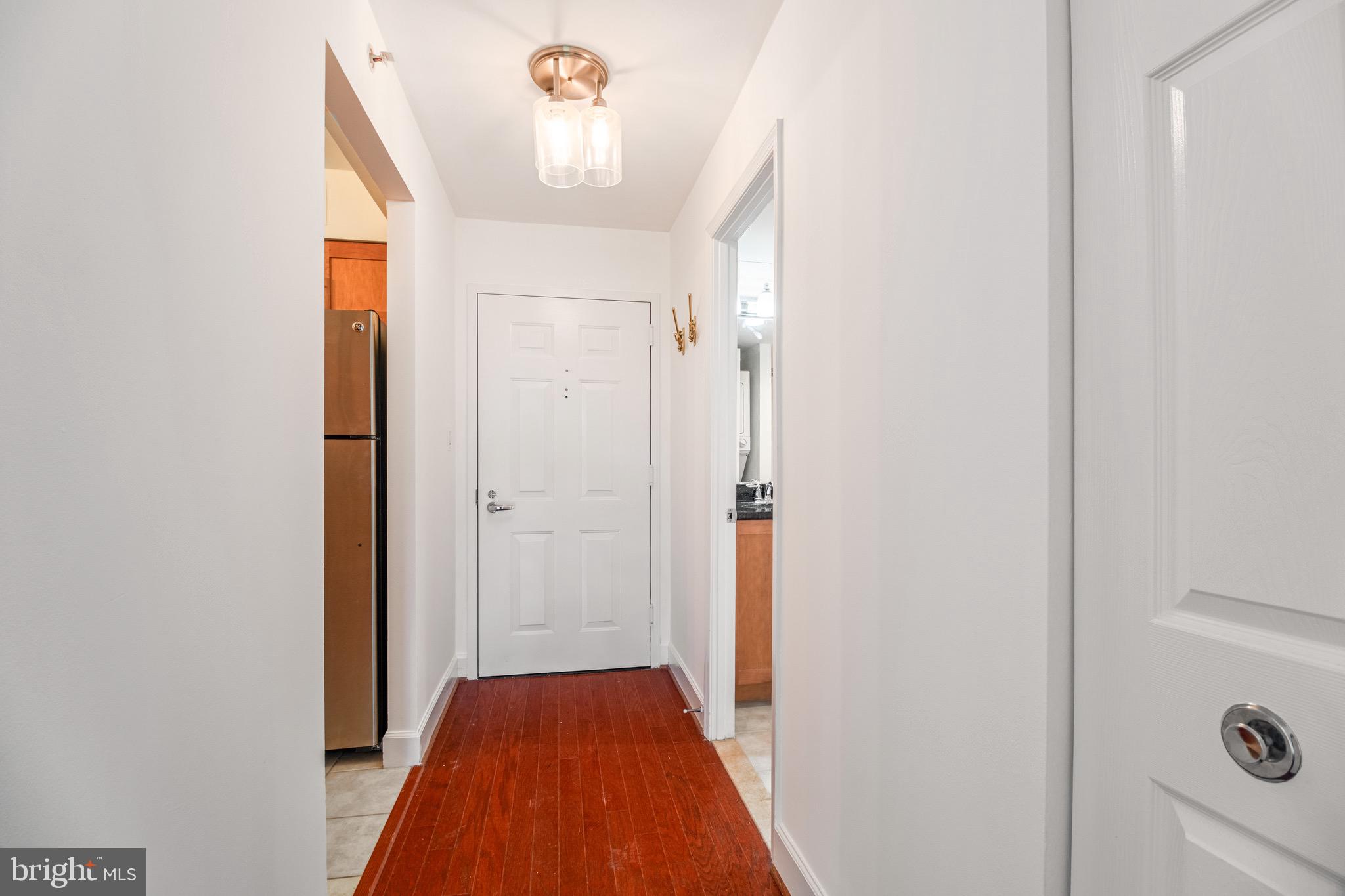 3401 38th Street Northwest, Unit 324 Washington, DC 20016 - Photo 4 of 23 a view of a hallway with a chandelier