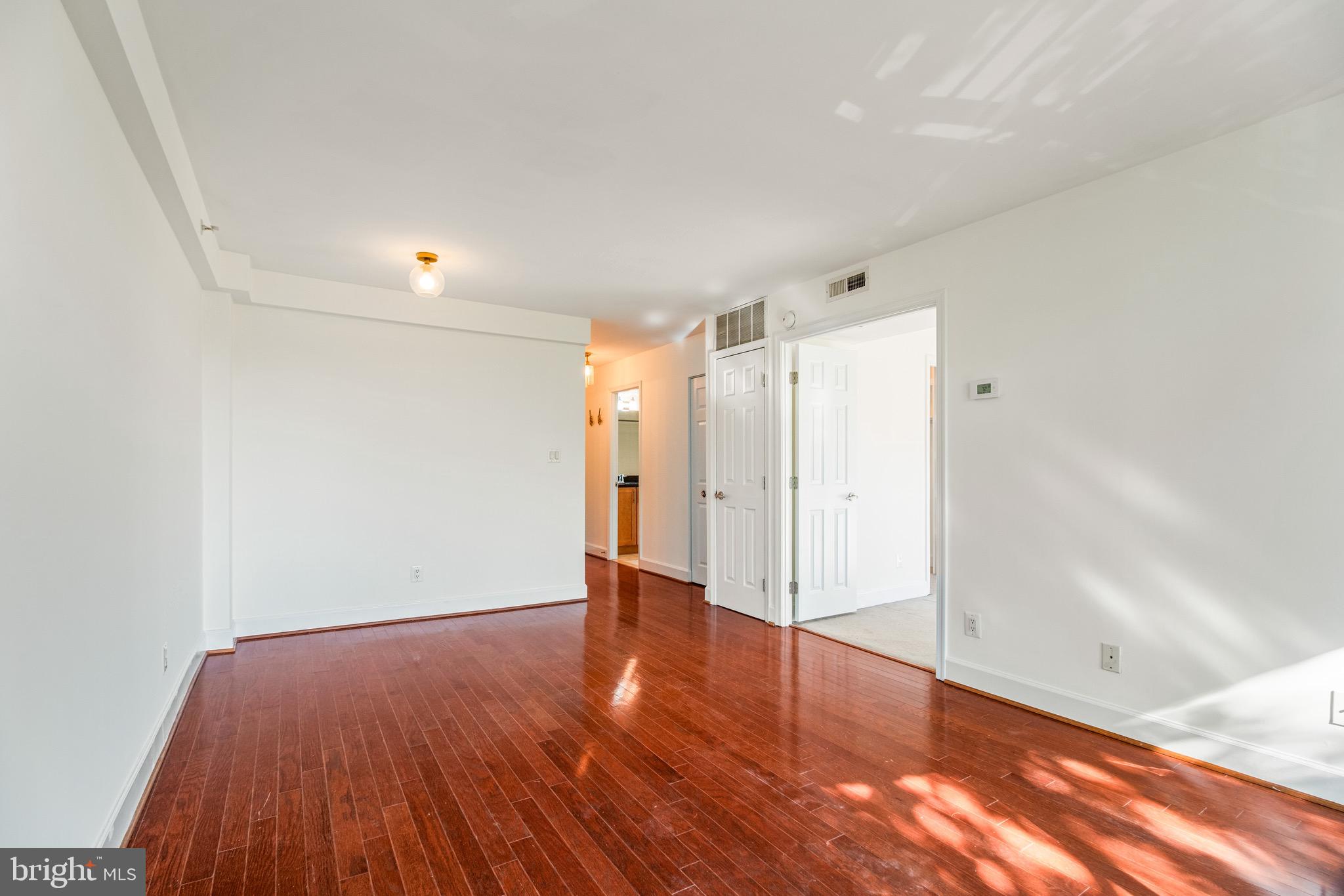 3401 38th Street Northwest, Unit 324 Washington, DC 20016 - Photo 6 of 23 a view of an empty room with wooden floor