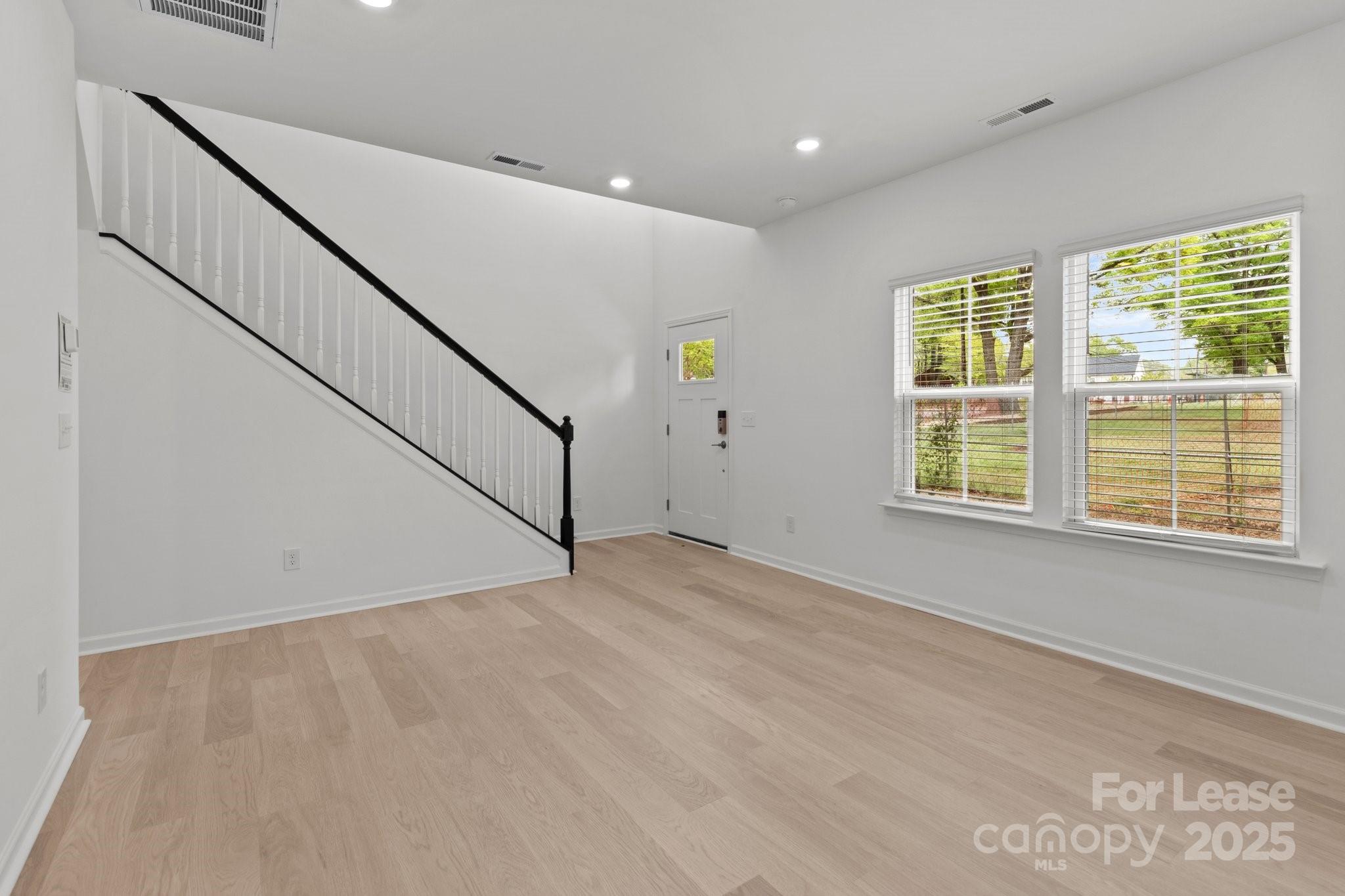 109 Goodson Place Davidson, NC 28036 - Photo 20 of 22 a view of an empty room with wooden floor and a window