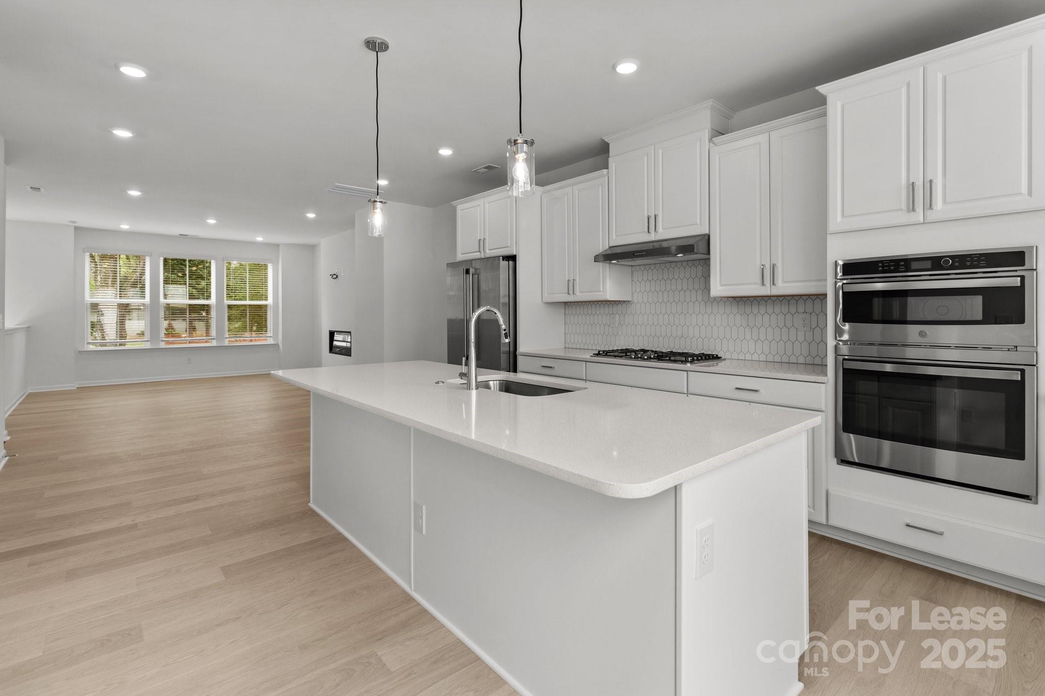 109 Goodson Place Davidson, NC 28036 - Photo 5 of 22 a kitchen with stainless steel appliances granite countertop a sink a stove and a refrigerator