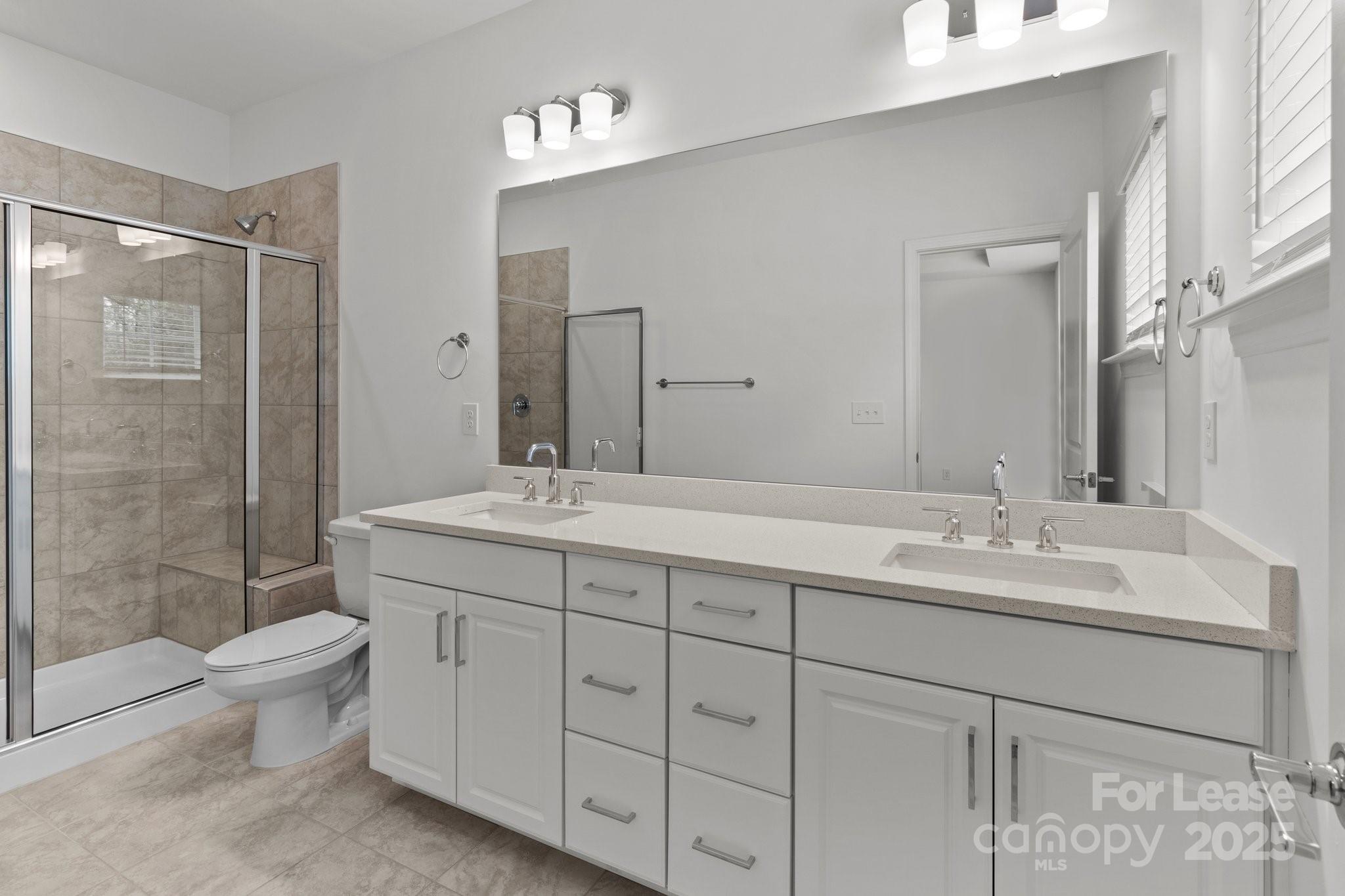 109 Goodson Place Davidson, NC 28036 - Photo 10 of 22 a bathroom with a double vanity sink toilet and shower