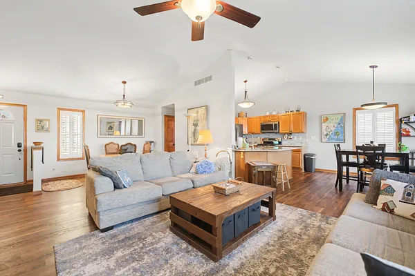 a living room with furniture wooden floor and chandelier