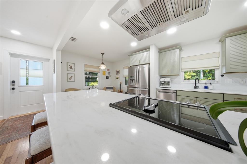 1830 Main Street Safety Harbor, FL 34695 - Photo 19 of 90 a kitchen with kitchen island granite countertop a sink a counter top space and stainless steel appliances
