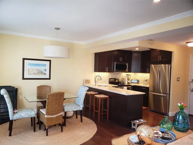 a kitchen with stainless steel appliances granite countertop a refrigerator and a stove top oven