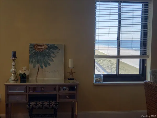 a room with a window and a potted plant