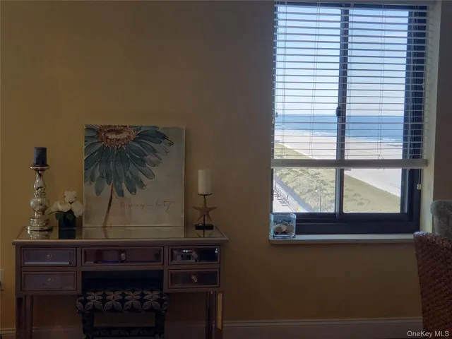 a room with a window and a potted plant