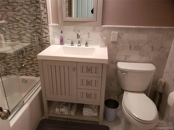 a bathroom with a toilet a sink and a bathtub