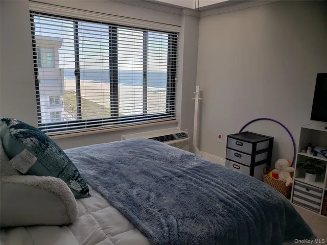 a bedroom with a bed and a large window