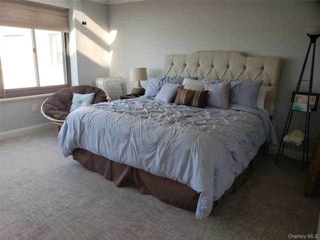 a bedroom with a bed and a night stand