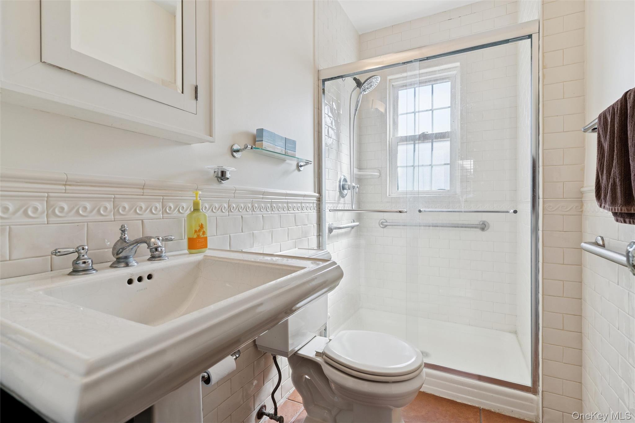 9 Troy Place Merrick, NY 11566 - Photo 12 of 23 a bathroom with a sink a toilet and shower