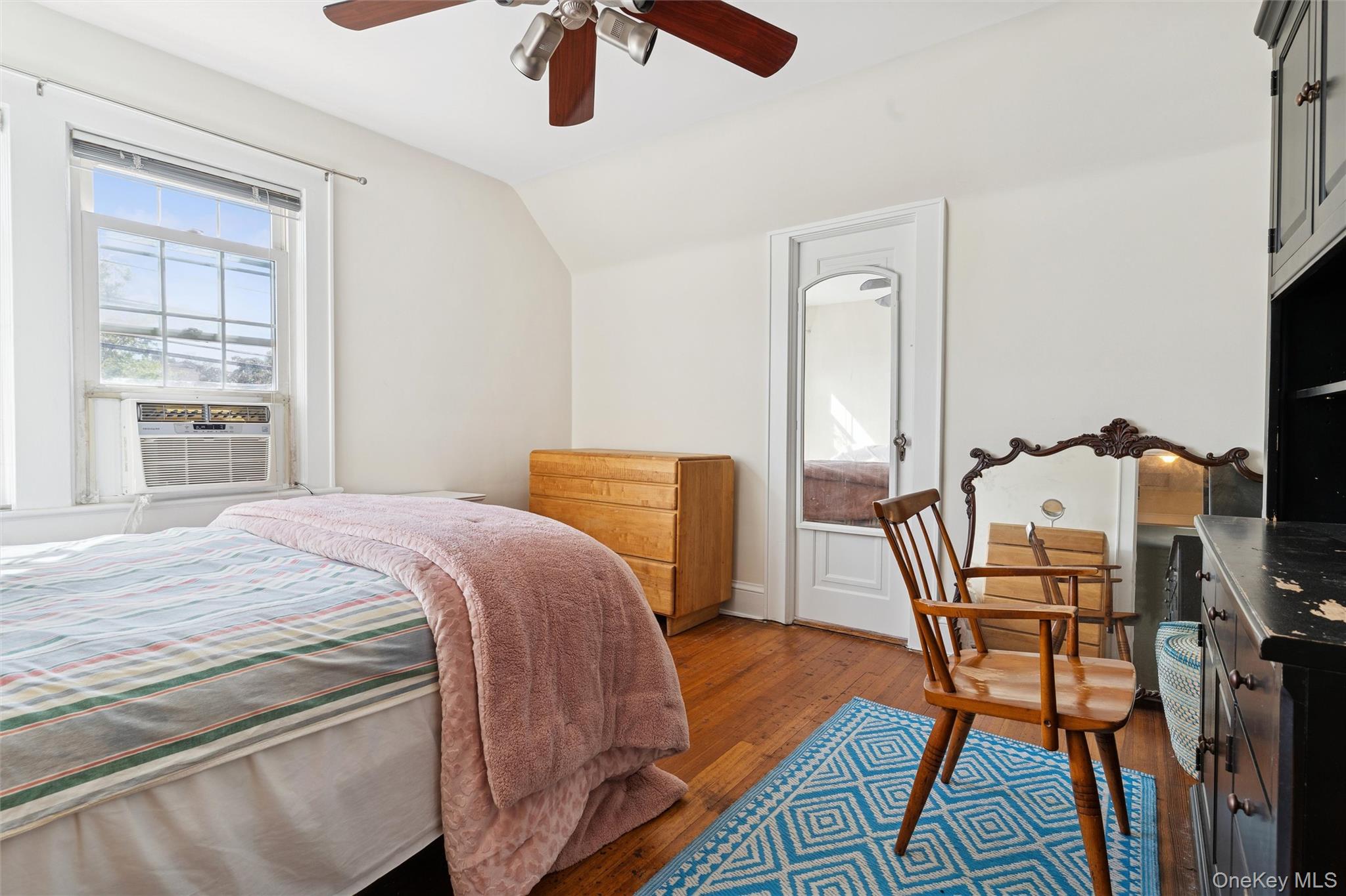 9 Troy Place Merrick, NY 11566 - Photo 19 of 23 a bedroom with a bed and wooden floor