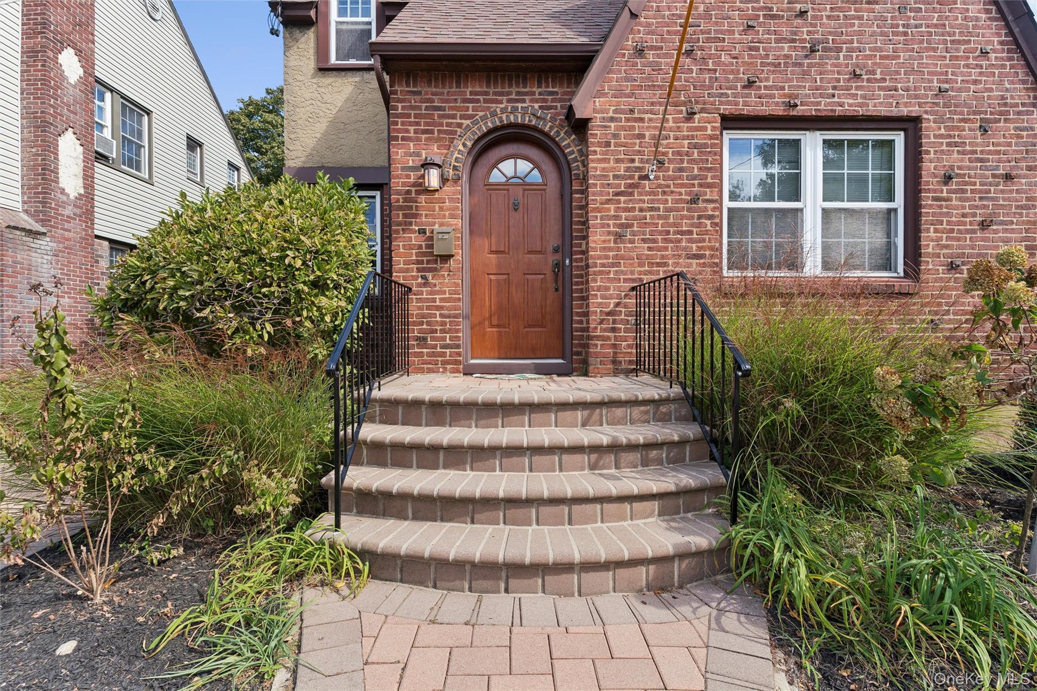 9 Troy Place Merrick, NY 11566 - Photo 21 of 23 a front view of a house with a garden