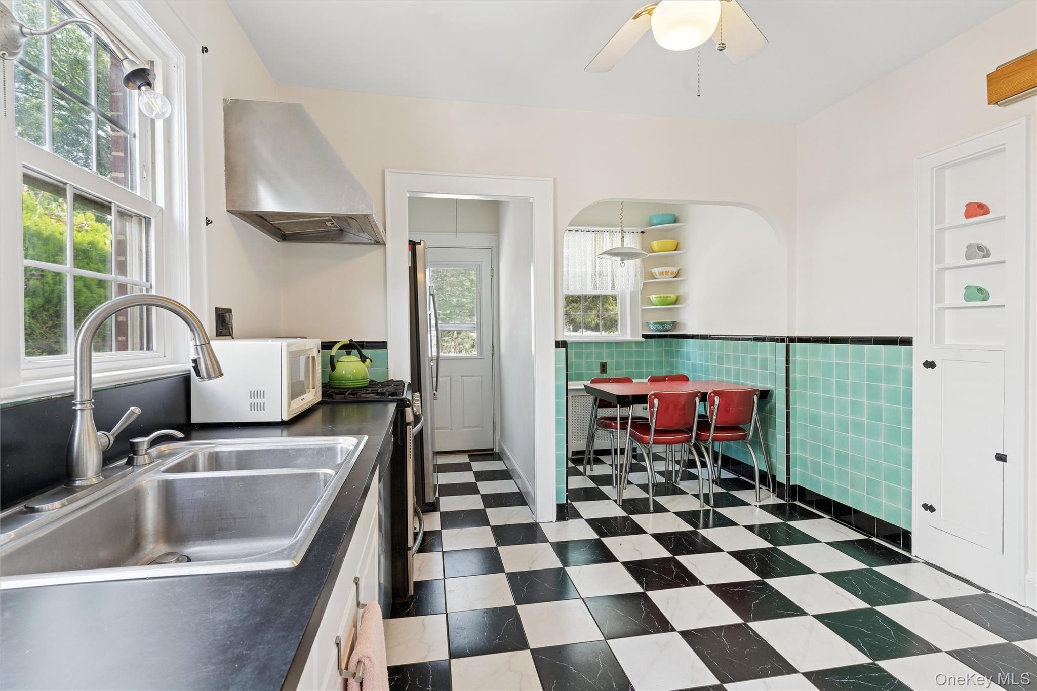 9 Troy Place Merrick, NY 11566 - Photo 8 of 23 a kitchen with a sink a refrigerator a window and a stove top oven