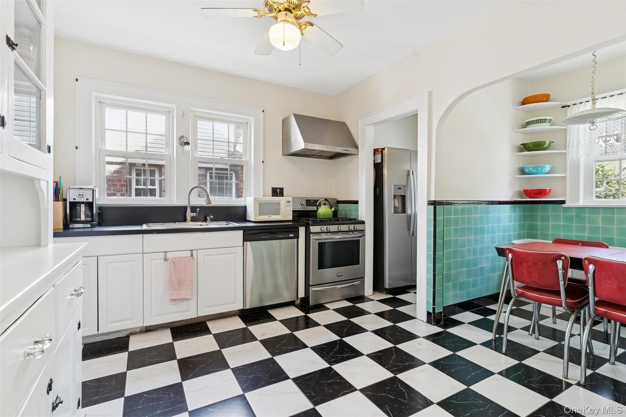 9 Troy Place Merrick, NY 11566 - Photo 10 of 23 a kitchen with stainless steel appliances kitchen island granite countertop a refrigerator and a stove top oven