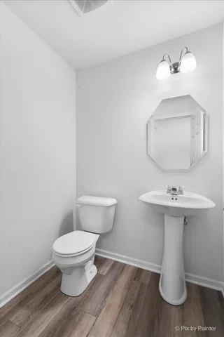 a bathroom with a sink toilet and a mirror