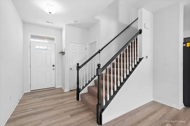 a view of an entryway with wooden floor
