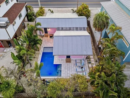 an aerial view of a house with outdoor space and sitting area