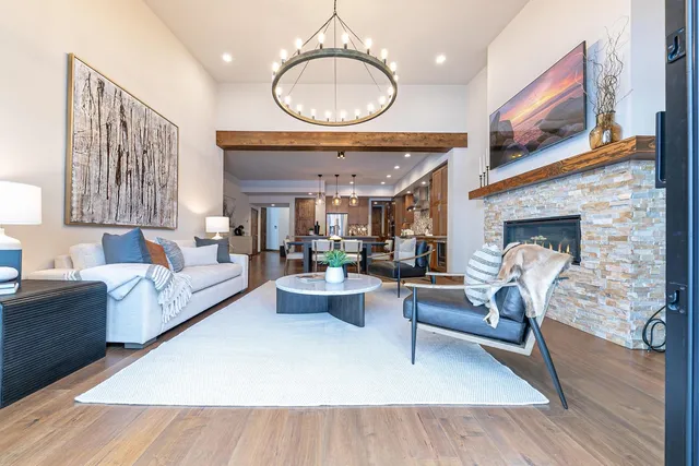 a living room with furniture a fireplace and a large window