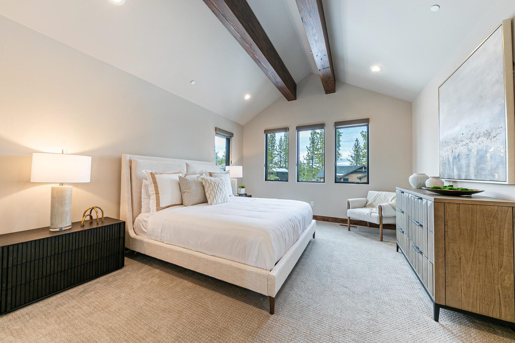 10232 Modane Place Truckee, CA 96161 - Photo 16 of 26 a spacious bedroom with a bed and a couch