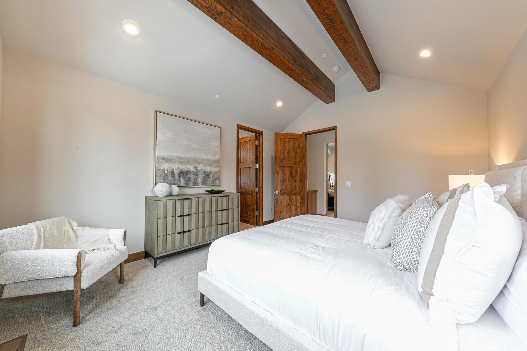 10232 Modane Place Truckee, CA 96161 - Photo 17 of 26 a spacious bedroom with a bed and a couch