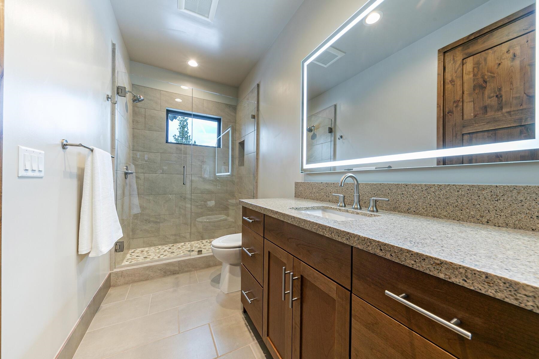 10232 Modane Place Truckee, CA 96161 - Photo 18 of 26 a bathroom with a granite countertop sink mirror bathtub and toilet