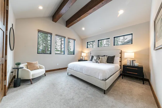 a spacious bedroom with a bed and a couch