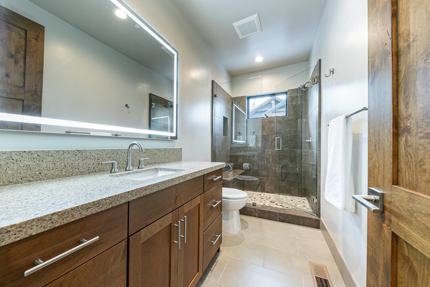 10232 Modane Place Truckee, CA 96161 - Photo 20 of 26 a bathroom with a sink a toilet a mirror and shower
