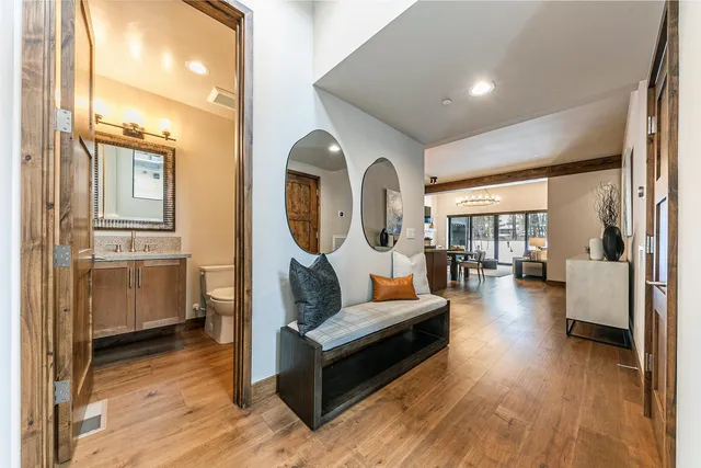 a living room with furniture and a wooden floor
