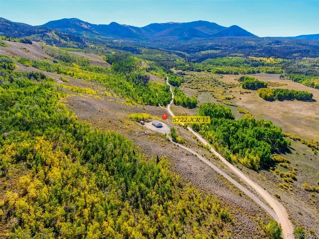 a view of a lush green hillside and a houses