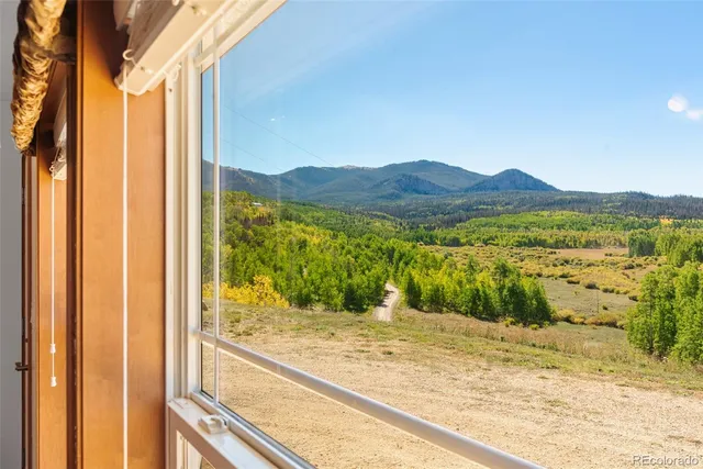 a view of a balcony with a yard