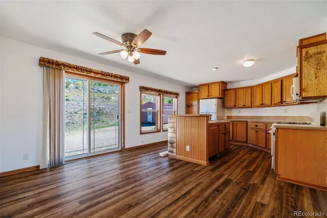 a living room with furniture a flat screen tv and wooden floor
