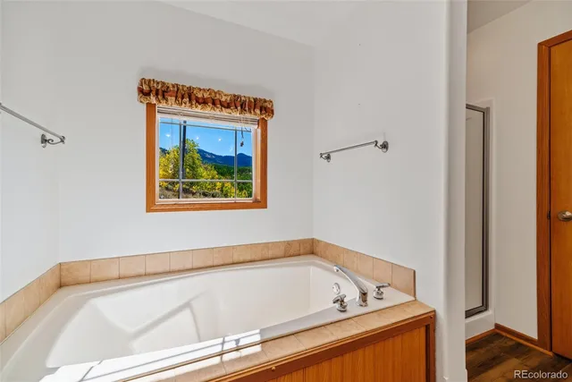 a bathroom with a bathtub and a window