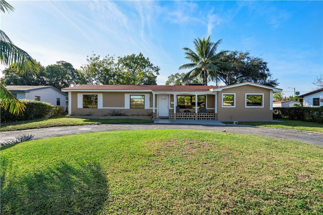 a front view of house with yard and green space