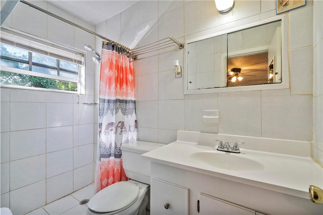 Undisclosed Address Miami, FL 33169 - Photo 18 of 24 a bathroom with a sink vanity mirror and toilet