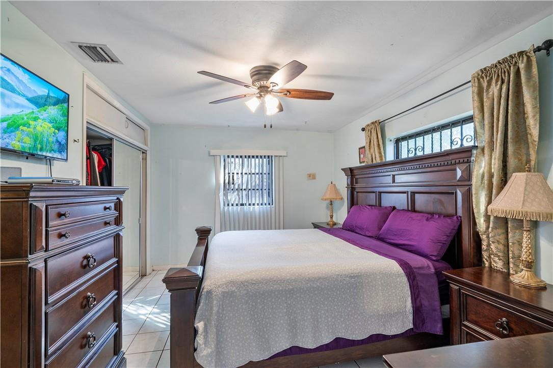 Undisclosed Address Miami, FL 33169 - Photo 19 of 24 a bedroom with a bed and a flat screen tv