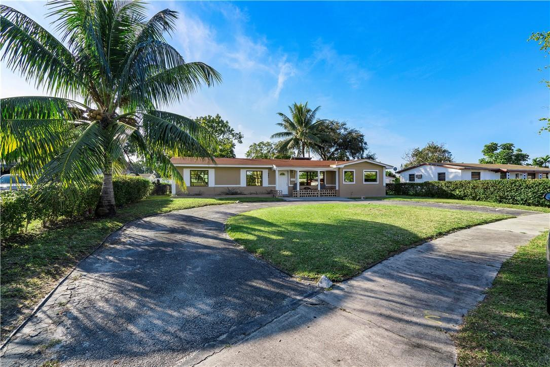 Undisclosed Address Miami, FL 33169 - Photo 2 of 24 a front view of house with yard and green space